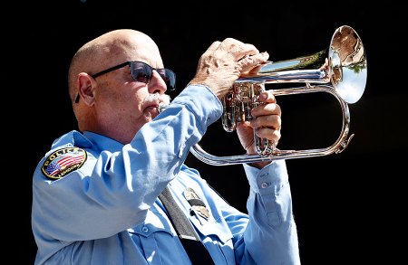 Retired officer, Tracy Landrus, plays taps.